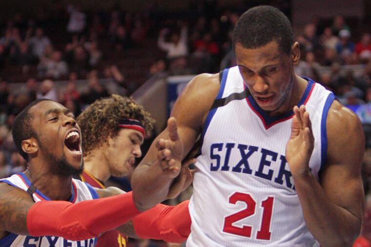 Tony Wroten (8) helps his teammate Thaddeus Young (21) celebrate his basket against the Cavaliers during the third quarter. (Steven M. Falk/Staff Photographer)