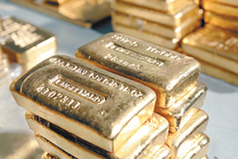Stacks of gold bars at FideliTrade, near Wilmington. Usually, the bars are not moved - the firm just keeps track of who trades it and where it is. (Michael Perez/Inquirer)