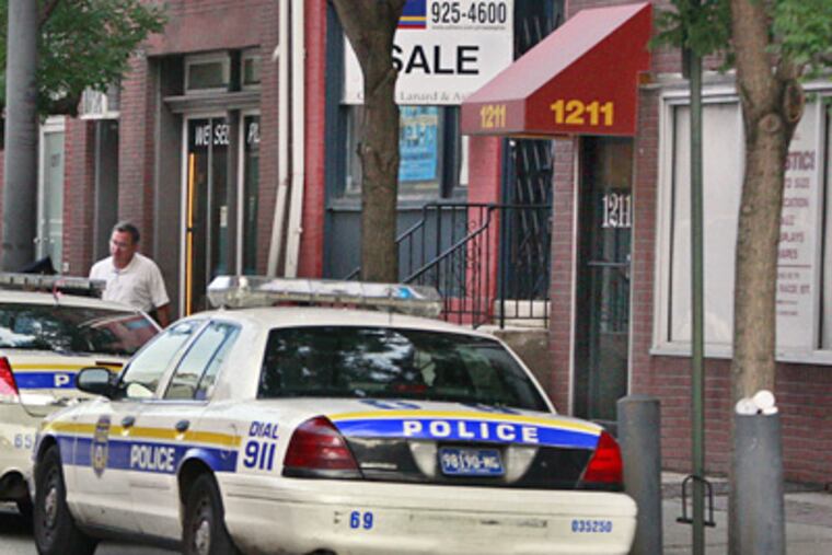 Police keep the scene secure at 1211 Race Street in Philadelphia where an armed robbery of a massage parlor occurred at around 3 a.m. yesterday. (Elizabeth Robertson/Staff Photographer)
