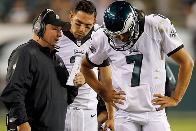 Eagles quarterback Sam Bradford listens to head coach Chip Kelly.