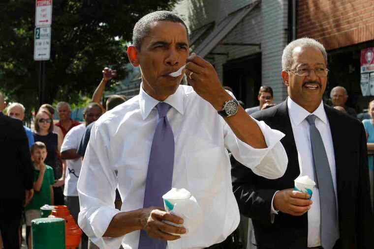 Obama tries the lemon water ice at John's in South Philly, with U.S. Rep. Chaka Fattah at his side.