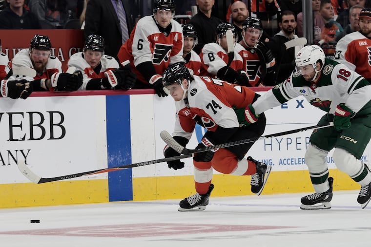 Owen Tippett of the Flyers chases down the puck as the Wild’s Vinnie Hinostroza (18) pursues him in overtime Saturday.