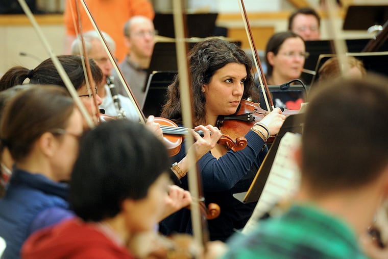 Katrina Christoforidis of Drexel Hill, second violinist, rehearses with other members of the Lansdowne Symphony at Temple Adath Israel in Merion. The 80 or so players get together weekly.