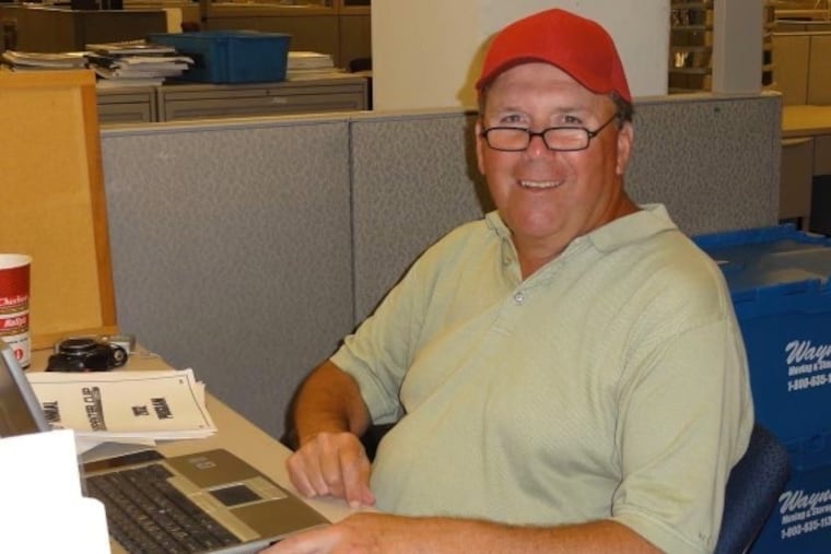 Mr. Silary works at his desk in the Daily News office. "Ted knew how valuable a write-up was to every child’s family and his community," a former colleague said.