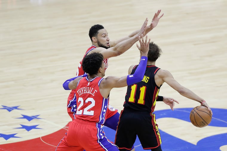 Sixers guards Ben Simmons and Matisse Thybulle defending Atlanta Hawks guard Trae Young in Game 1 of the NBA Eastern Conference playoff semifinals on June 6.