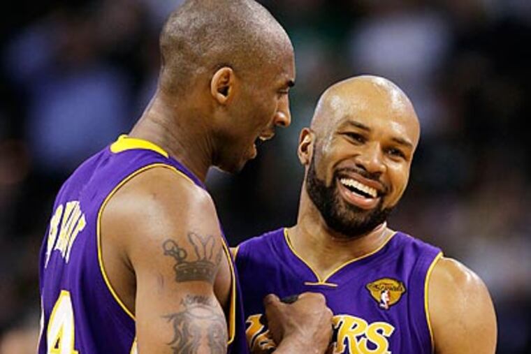 Kobe Bryant and Derek Fisher celebrate in the closing moments of the Lakers' win. (Michael Dwyer/AP)