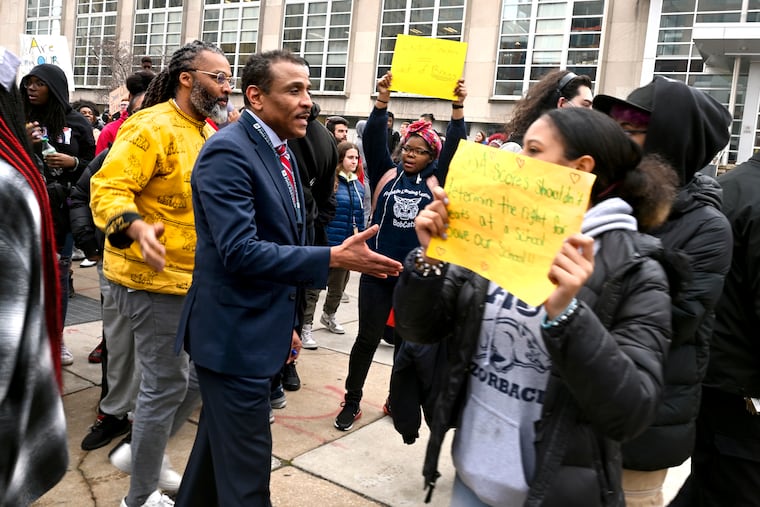 Superintendent Tony Watlington (right) and school board president Reginald Streater (left) speak to students demonstrating outside Philadelphia School District headquarters.