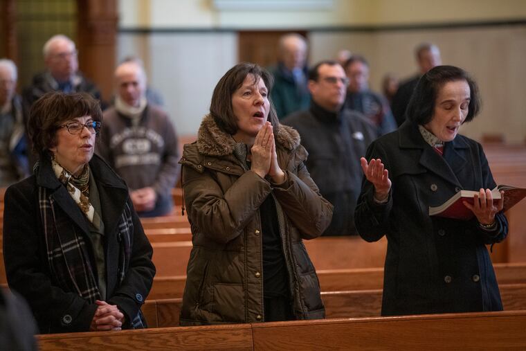 From left to right, Mary Ann Tancredi, Colleen Samson, and Gianna Molo celebrate Mass in the chapel at the Cathedral Chapel at the Basilica of St Peter Paul on January 23, 2020, the same day the Archdiocese announced the new Archbishop-elect, Nelson J. Pérez.