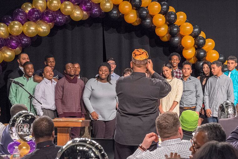 The nearly 40 graduates of Camelot Excel Academy pose during commencement at the Salvation Army Kroc Center in Camden. The program helps students who have dropped out or fallen behind.