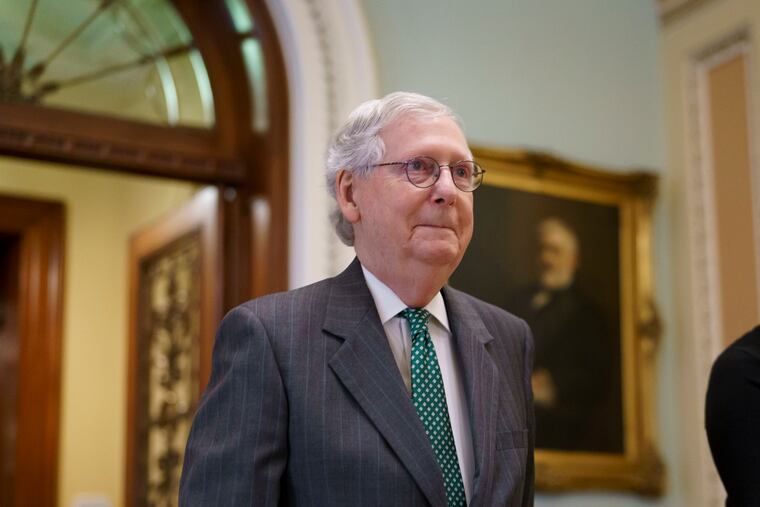 Senate Minority Leader Mitch McConnell, R-Ky., leaves the chamber Thursday as lawmakers work to advance the $1 trillion bipartisan bill, at the Capitol in Washington.