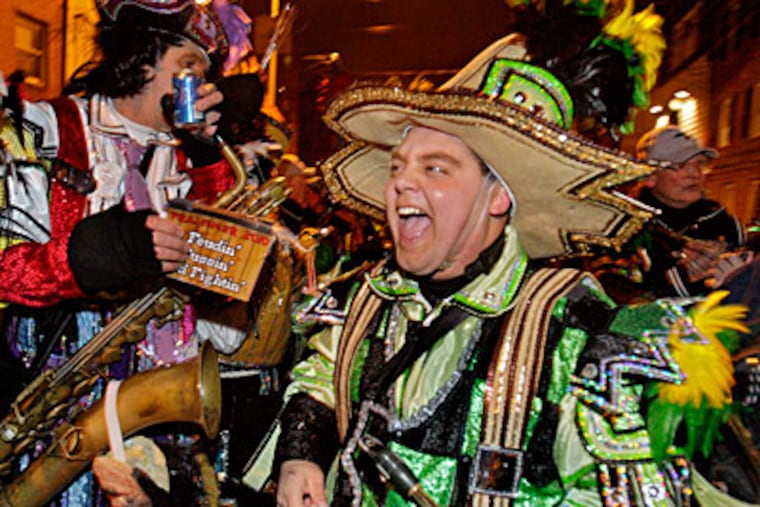On 2nd Street in South Philadelphia, saxaphone player Bob Griffiths of Gloucester City and other members of the Fralinger String Band celebrate their eighth straight 1st place finish. ( Elizabeth Robertson / Staff Photographer )