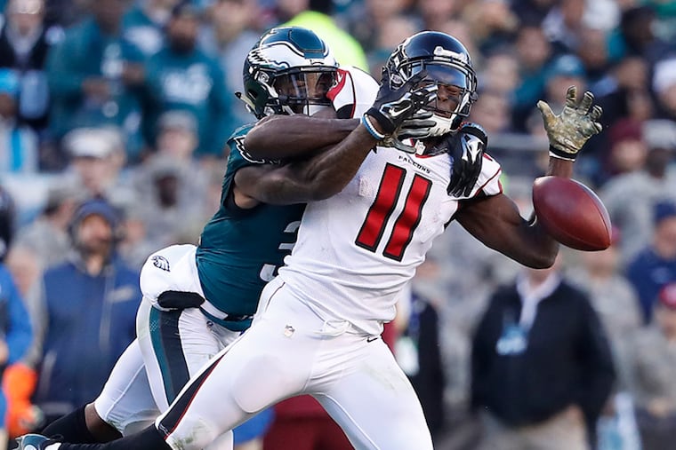 Jalen Mills (left) defends against Julio Jones in a November 2016 game.