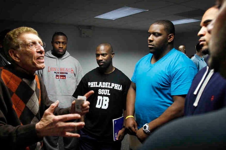 Marketing firm owner Gene Kolber (left) talks to Soul players Millicent Olawale (second from left), Keith Stokes, (third from left) and Michael Ward (fourth from left) at the team-sponsored job fair.