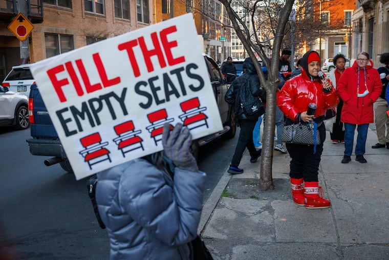 Dana Williams (right), a dance instructor at Franklin Learning Center for 17 years, addresses other teachers, students and parents gathered outside the school to rally against school district cuts to schools forced by changes to the district's special admissions policy.