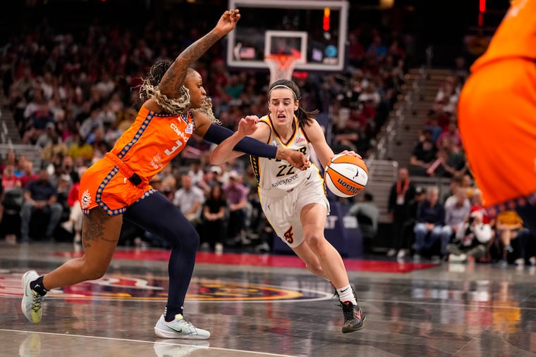 Indiana Fever guard Caitlin Clark drives on the Connecticut Sun's Tiffany Mitchell on Monday.
