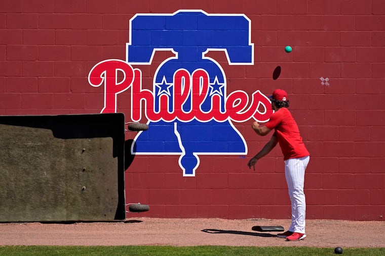 A Phillies minor-leaguer warms up for a game in 2021.