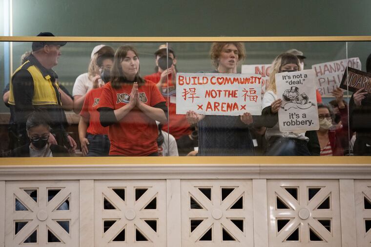 Demonstrators gather at a meeting in City Hall on legislation related to the construction of the Sixers arena on Wednesday.