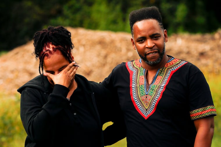 Mister Mann Frisby (right) consoles Kesha Walley-Cade near the Mann Music Center where the body of Shilie Turner was found 27 years ago. Shilie was a high school track star with dreams of participating in the Olympics. Frisby revisited the infamous case to produce an Oxygen channel show called "Buried in the Backyard."