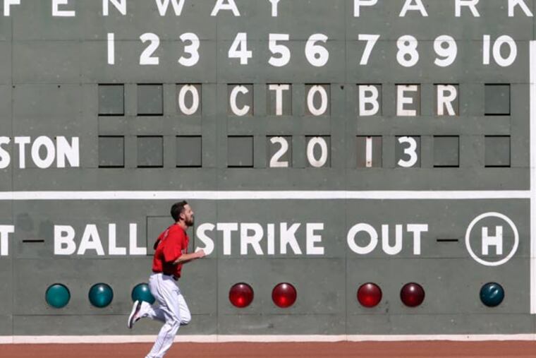 Red Sox starting pitcher John Lackey runs during a baseball practice at Fenway Park, Thursday, Oct. 3, 2013, in Boston. The Red Sox will face the Tampa Bay Rays in Game 1 of the American League Division Series on Friday in Boston. (Charles Krupa/AP)