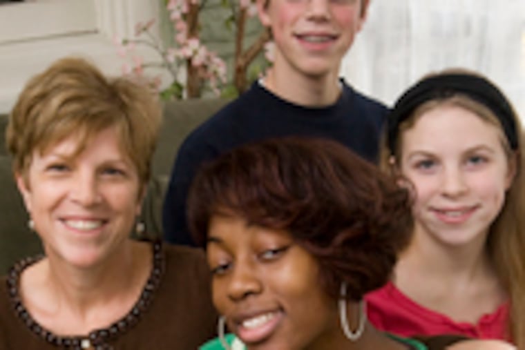 Giving and receiving love that has changed their lives are (photos clockwise from top left): Kyler Vannocker, on his mother Maria's lap, giving a high-five to Dr. Marta Rozans; Danielle Wheeler (center) with (from left) Terry Whitaker, Whitaker's son Leo Koorhan and daughter Sophie Koorhan; and Chinika Perez, embraced by attorney Jerry Dugan.