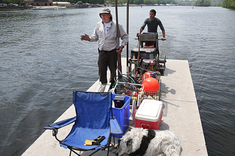 Al Wachlin, left, and Ethan Santiago, right, along with Miss Pippin, Wachlin's dog, check the lane bouys during the Aberdeen Dad Vail Regatta in Philadelphia, Pa. on May 8, 2015. (David Maialetti/Staff Photographer)