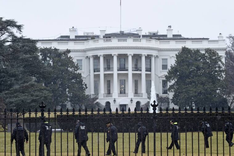 FILE - In this Jan. 26, 2015 file photo, Secret Service officers search the south grounds of the White House in Washington after an unmanned aerial drone was found on the White House grounds during the middle of the night. The Secret Service is investigating two senior agents after a car crash at the White House complex. Secret Service spokesman Robert Hoback says recently appointed Director Joseph Clancy has been briefed on the March 4 incident. (AP Photo/Susan Walsh, File)