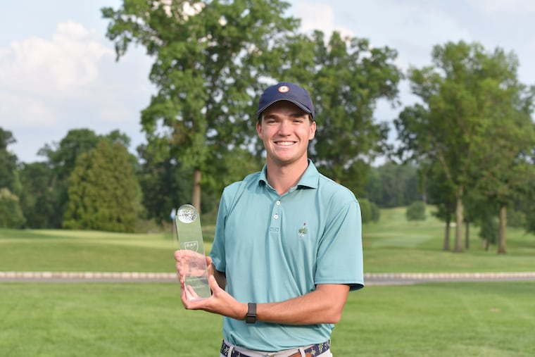 Peter Bradbeer of Merion holds the medalist trophy for carding the lowest score Monday in BMW Philadelphia Amateur Championship qualifying.