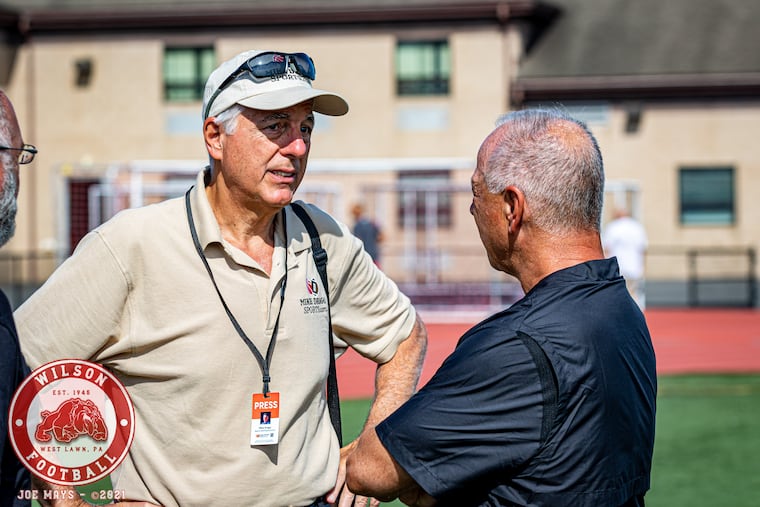 Mike Drago (left) talks with fJim Cantafio, an assistant coach with the Coatesville high school football team. Cantafio was formerly head coach of the Wilson Bulldogs, a high school in Berks County.