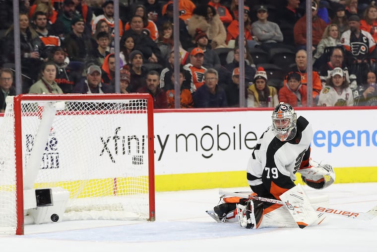 Flyers goaltender Carter Hart watches Chicago Blackhawks Reese Johnson's second period goal on Thursday, January 19, 2023 in Philadelphia.
