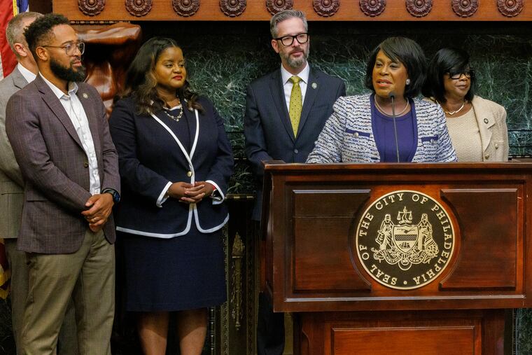 Philadelphia Mayor Cherelle Parker speaks at a news conference Friday and is joined by outgoing Chief Deputy Mayor Aren Platt, center, and his replacement Vanessa Garrett-Harley, right.