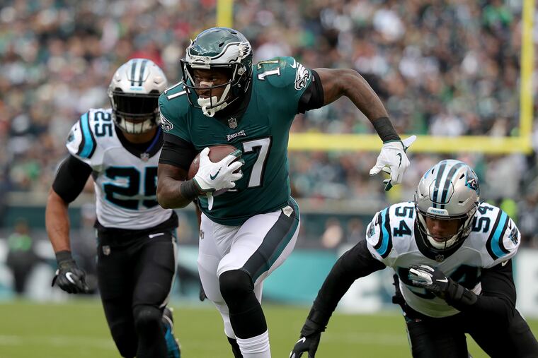 Eagles Alshon Jeffery, center, gets by Panthers defenders Eric Reid, left, and Shaq Thompson, right, during the 2nd quarter as the Philadelphia Eagles play the Carolina Panthers in Philadelphia, PA on October 21, 2018. DAVID MAIALETTI / Staff Photographer