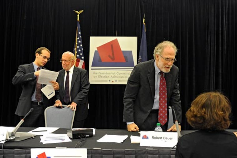 Presidential Commission on Election Administration co-chairmen Robert Bauer (right), and Benjamin Ginsberg (2nd from left) confer with people prior to the start of the afternoon session at the PA Convention Center Sept. 4, 2013. This is the third of fourth meetings the commission is holding in different sections of the country. ( CLEM MURRAY / Staff Photographer )