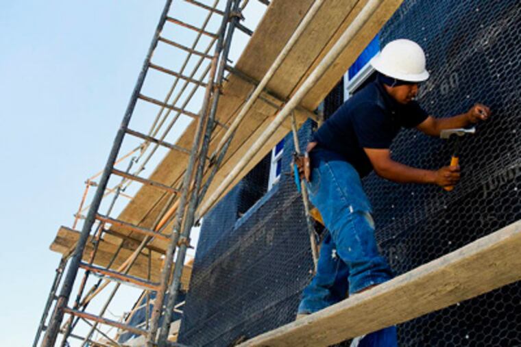 A laborer builds a home in the San Elijo Hills community of San Diego, California, U.S.