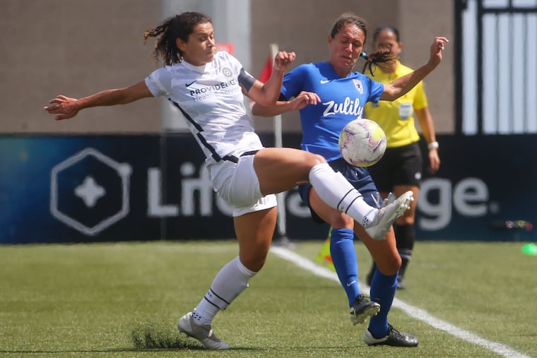Portland Thorns midfielder Raquel Rodríguez (left) and OL Reign defender Steph Cox (right) fighting for the ball during the first half.
