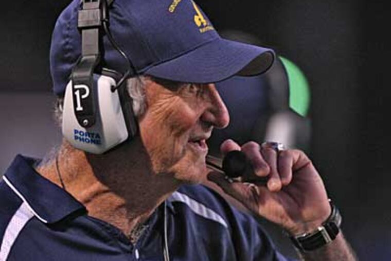 George Washington head coach Ron Cohen on the headset while leading in second quarter at Memorial Stadium. ( David M Warren / Staff Photographer )