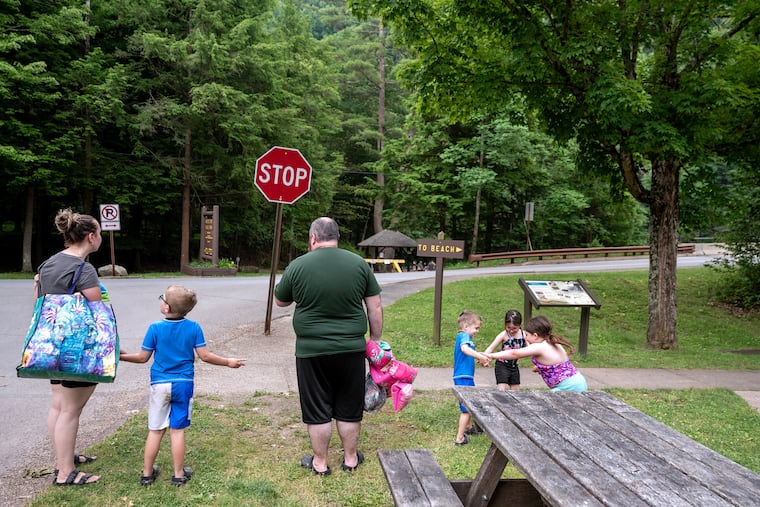People walk toward the beach at Worlds End State Park, along the Loyalsock Creek, just south of Forksville, in this June 2024 file photo. Pennsylvania's state parks saw nearly 25 million visitors in summer 2025, after federal cutes closed more than 425 campsites across the commonwealth.