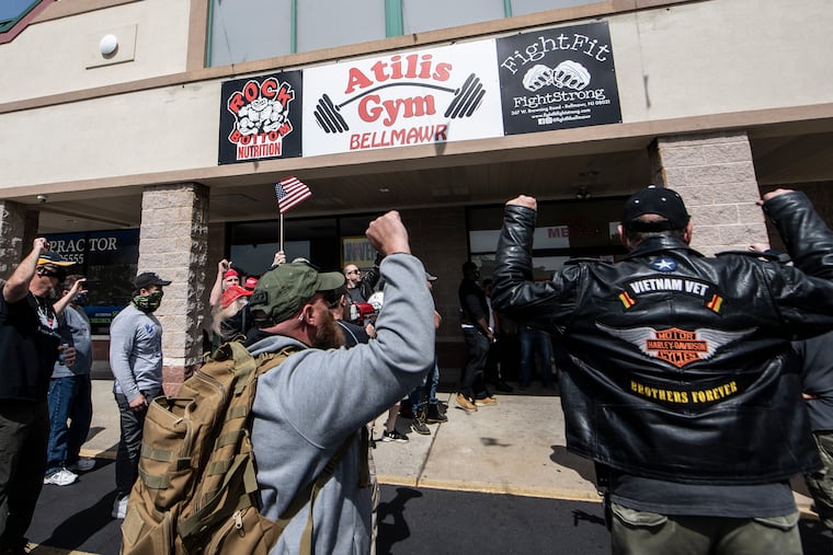 People gather in support of Atilis Gym in Bellmawr, N.J. The gym in New Jersey reopened for business earlier this week, defying a state order that shut down nonessential businesses to help stem the spread of the coronavirus. Gyms have led the way in defying state-mandated shutdowns amid the coronavirus pandemic.