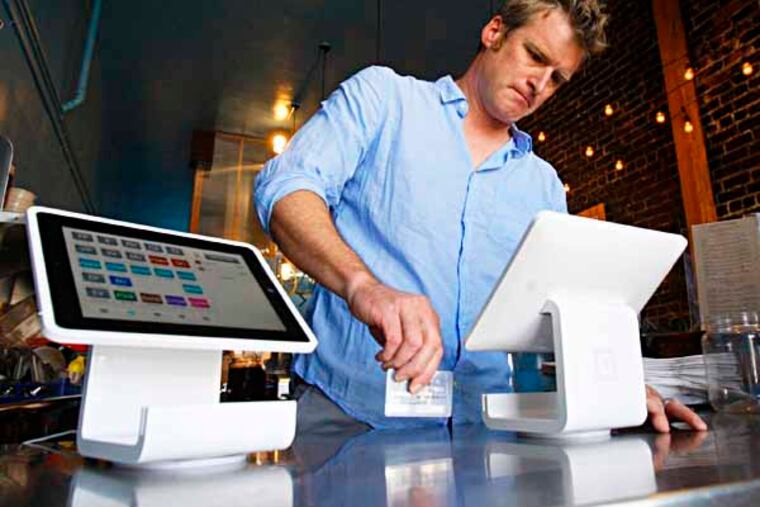 Matt Schodorf, owner of Schodorf's Luncheonette, swipes a credit card on the Square Stand at his restaurant, in the Highland Park area of Los Angeles on June 5, 2013. The Square Stand rings customers up on Squares applications. Merchants fed up with the clunky system they have for processing credit and debit card payments are moving increasingly to credit card swiping machines that plug into mobile pads. (Gary Friedman/Los Angeles Times/MCT)