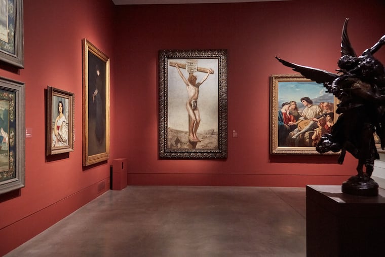 "The Crucifixion" (1880) by Thomas Eakins on display in the Philadelphia Museum of Art’s Salon Gallery. On the left: James McNeill Whistler, an American contemporary of Eakins. On the right: Thomas Couture, a French artist who Eakins admired.