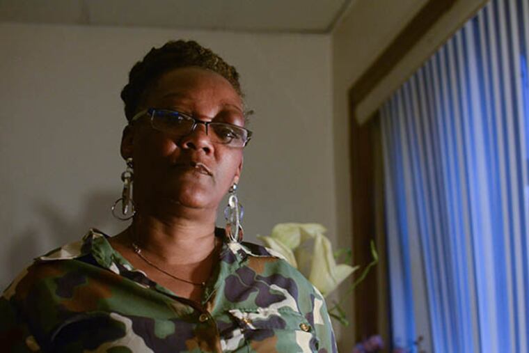 Brendale McAfee, 57, stands in her North Philadelphia home on Wednesday, May 28, 2014. McAfee was held captive and tortured in 2010 by a man who used to offer her protection when she worked as a prostitute, but she escaped and turned her life around. (Andrew Thayer / Staff Photographer)