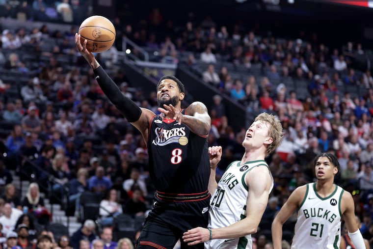 Sixers forward Paul George drives to the basket against Milwaukee Bucks guard AJ Green during the first quarter on Sunday, April 12, 2026 in Philadelphia.