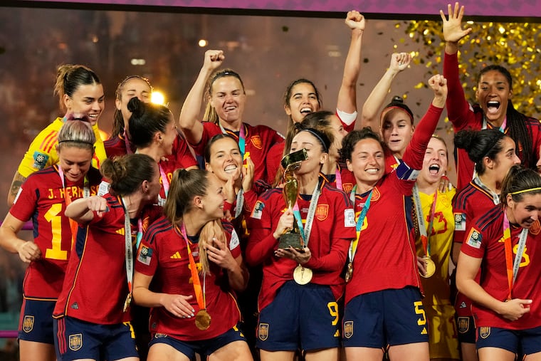 Spain's team celebrates with the trophy after winning the women's World Cup.