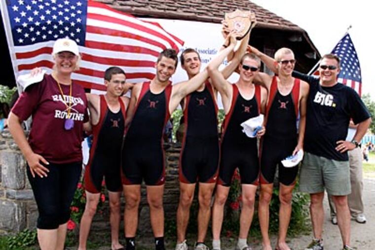 Radnor rowers and coaches hoist the championship plaque after they won the varsity four with coxswain at the Scholastic Rowing Association of America’s national championships on the Cooper River in Pennsauken, N.J. From left are coach Valeria Gospodinov, Ben Croop, Jimmy Puckette, Cameron Staines, Declan Carbery, JP Aftring, and rowing director Ken Piree
