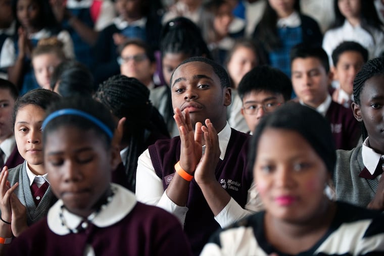 Faheem Sultan (center), 13, was among students and parents at the National Constitution Center to fill out applications for the Philadelphia Children’s Scholarship Fund.