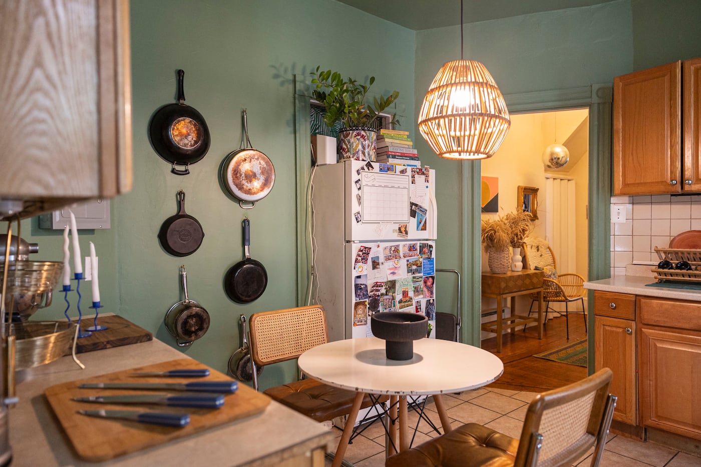 Using wall space to hang pots and pans is one of Huston's best tricks for getting the most out of her apartment's kitchen. She's done it in previous homes too.