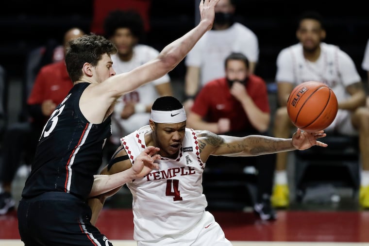 Temple forward J.P. Moorman II loses the basketball as Cincinnati center Chris Vogt defends him during the second half.