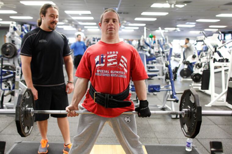 Trainer Blake Kondras spots David Praiss (right) as he does a dead lift during a workout at Royal Fitness in Barrington. Praiss, 40, was recently awarded the 2012 Athlete of the Year by the Special Olympics of New Jersey. ( MICHAEL S. WIRTZ / STAFF PHOTOGRAPHER ).