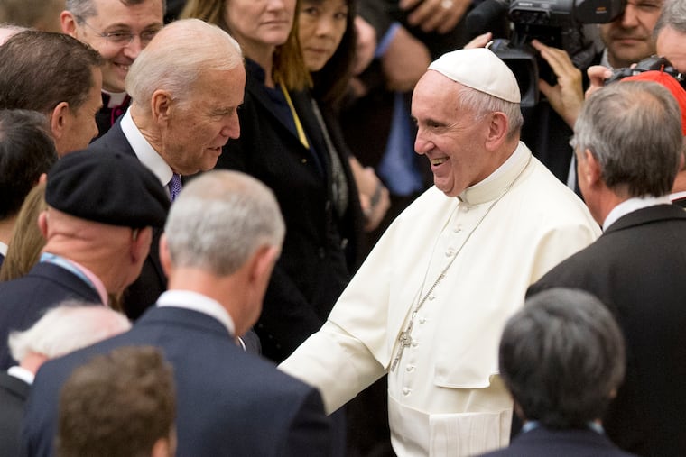 In this April 29, 2016, photo, then-Vice President Joe Biden shakes hands with Pope Francis during a congress on the progress of regenerative medicine held at the Vatican.