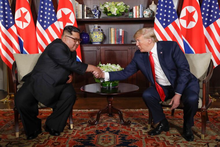 In this Tuesday, June 12, 2018, file photo, North Korea leader Kim Jong Un, left, and U.S. President Donald Trump shake hands during their first meeting at the Capella resort on Sentosa Island in Singapore.