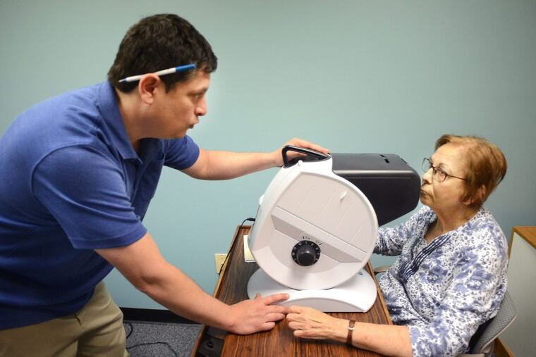 Sonia Margolis, 77, of Warminster, has her vision tested by Dennis Magrann, a certified driver rehabilitation specialist at MossRehab as she is evaluated for driving.